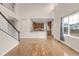 Bright living room with hardwood floors, open to the kitchen and large window at 110 Gold Maple St, Brighton, CO 80601