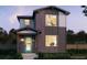 Charming two-story home with a mix of stone and siding, plus a light blue door and covered porch at 21001 E 63Rd Dr, Aurora, CO 80019
