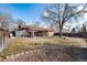 Expansive backyard with mature trees, storage shed, back porch, and well-maintained lawn at 2993 S Zenobia St, Denver, CO 80236