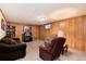 Finished basement with wood paneling, comfortable seating, and a television at 2993 S Zenobia St, Denver, CO 80236