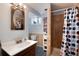 Bathroom featuring a modern vanity, a large mirror, and a shower with decorative shower curtain at 2993 S Zenobia St, Denver, CO 80236