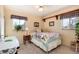 Bedroom with a colorful quilt, two windows, and light yellow walls at 2993 S Zenobia St, Denver, CO 80236