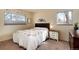 Cozy bedroom features a floral quilt, wooden accents, and natural light from two windows at 2993 S Zenobia St, Denver, CO 80236