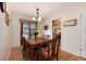 A dining room furnished with a wooden table and seating for six, adjacent to sliding glass doors at 2993 S Zenobia St, Denver, CO 80236