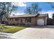 A well kept home with brick facade, mature trees and a driveway leading to an attached one car garage at 2993 S Zenobia St, Denver, CO 80236