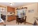 Sunlit kitchen boasts tile flooring, wooden cabinetry, and a breakfast table overlooking the backyard at 2993 S Zenobia St, Denver, CO 80236