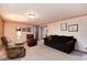 Comfortable living room featuring a brown sofa and recliner chairs with neutral carpet and decor at 2993 S Zenobia St, Denver, CO 80236