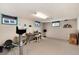 Expansive recreation room with neutral carpet, bright lighting, and plenty of open space at 2993 S Zenobia St, Denver, CO 80236