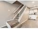 Carpeted staircase leading to the next level of the home, with white railing at 12053 E Tennessee Ave, Aurora, CO 80012