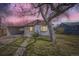 Charming single-story home with a covered parking area and a mature tree in the front yard at 1280 S Quitman St, Denver, CO 80219