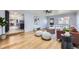 Bright living room with modern decor, wood floors, and an open layout leading to the kitchen at 1280 S Quitman St, Denver, CO 80219