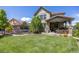 Expansive backyard with a covered patio, trampoline, and plenty of space for outdoor activities at 10590 Soulmark Way, Highlands Ranch, CO 80126
