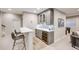 Basement bar area with counter seating, wine cooler, and ample storage at 10590 Soulmark Way, Highlands Ranch, CO 80126