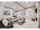 Cozy basement lounge area featuring a sectional sofa, fireplace and accent decor at 10590 Soulmark Way, Highlands Ranch, CO 80126