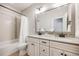 Cozy bathroom features a double vanity with white cabinetry, a tiled shower, and modern fixtures at 10590 Soulmark Way, Highlands Ranch, CO 80126