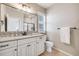 Bright bathroom featuring a white vanity, tile backsplash, framed mirror, and tiled floors at 10590 Soulmark Way, Highlands Ranch, CO 80126