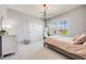 Comfortable bedroom featuring a large window, modern lighting, and stylish decor at 10590 Soulmark Way, Highlands Ranch, CO 80126