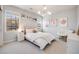 Inviting bedroom featuring a stylish bed, modern lighting, and large windows at 10590 Soulmark Way, Highlands Ranch, CO 80126