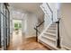 Open hallway with hardwood floors and staircase, creating a seamless transition between living spaces at 10590 Soulmark Way, Highlands Ranch, CO 80126