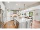 Kitchen with oversized island, stainless steel appliances, and adjacent dining area at 10590 Soulmark Way, Highlands Ranch, CO 80126
