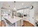 Spacious kitchen island with pendant lighting, stainless appliances and ample cabinet space at 10590 Soulmark Way, Highlands Ranch, CO 80126