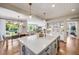 Open concept kitchen with a large island, stainless appliances, and view to dining and living areas at 10590 Soulmark Way, Highlands Ranch, CO 80126