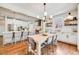 Bright kitchen with white cabinetry, stainless appliances, large center island and stylish dining table at 10590 Soulmark Way, Highlands Ranch, CO 80126