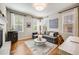 Comfortable living room featuring hardwood floors, bright windows, and a cozy seating area at 10590 Soulmark Way, Highlands Ranch, CO 80126