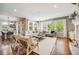 Spacious living room filled with natural light, hardwood floors, and a seamless connection to the dining area at 10590 Soulmark Way, Highlands Ranch, CO 80126