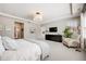 Bright main bedroom with tray ceiling, modern lighting, and ample space for seating at 10590 Soulmark Way, Highlands Ranch, CO 80126
