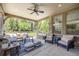 Inviting covered patio with comfortable seating and lush backyard view at 10590 Soulmark Way, Highlands Ranch, CO 80126