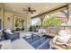 Relaxing outdoor patio with stylish furniture, ceiling fan, and easy access to indoor living spaces at 10590 Soulmark Way, Highlands Ranch, CO 80126