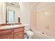 Bathroom features a vanity, mirror, toilet, tub and tile walls in a well-lit space at 2139 Coronado Pkwy # B, Denver, CO 80229