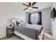 A cozy bedroom features a comfortable bed with soft gray covers and a modern ceiling fan at 2139 Coronado Pkwy # B, Denver, CO 80229
