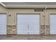 Garage exterior with white doors and brick detail, emphasizes functionality and curb appeal at 2139 Coronado Pkwy # B, Denver, CO 80229
