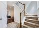 Bright foyer with a staircase featuring wood railing and neutral carpet at 2139 Coronado Pkwy # B, Denver, CO 80229