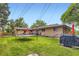 Large backyard with a well-maintained lawn, wooden privacy fence, grill, and comfortable outdoor seating at 555 W Mansfield Ave, Englewood, CO 80110