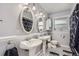 Bright bathroom featuring dual sinks and stylish black-and-white tile floor at 555 W Mansfield Ave, Englewood, CO 80110