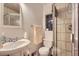 This bathroom features a sink, toilet, shower with glass door and tile surround, and a medicine cabinet at 555 W Mansfield Ave, Englewood, CO 80110