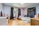 Cozy bedroom features hardwood floors, a plush bed, and a decorative mirror for a comfortable retreat at 555 W Mansfield Ave, Englewood, CO 80110