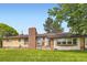 Single-Gathering home with brick chimney and front yard at 555 W Mansfield Ave, Englewood, CO 80110