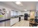 Functional kitchen with stainless steel refrigerator and ample cabinet space at 555 W Mansfield Ave, Englewood, CO 80110