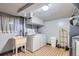Basement laundry room includes a washing machine, dryer, utility sink, and convenient access at 555 W Mansfield Ave, Englewood, CO 80110