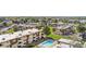 Extensive aerial view of a multi-unit residential area, featuring well-kept lawns, a pool, and organized parking at 10211 Ura Ln # 1-202, Thornton, CO 80260