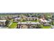 Aerial view of condo community with well-manicured lawns and mature trees at 10211 Ura Ln # 1-202, Thornton, CO 80260