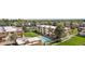 Aerial view showcasing well-maintained apartment complex, a pool, and nearby residential areas in a lush, green environment at 10211 Ura Ln # 1-202, Thornton, CO 80260