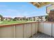 Relax on the balcony with views of the community's lush green space and neighboring residential buildings on a sunny day at 10211 Ura Ln # 1-202, Thornton, CO 80260