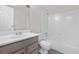 Bright, white bathroom featuring white vanity and tile tub and shower at 10211 Ura Ln # 1-202, Thornton, CO 80260