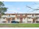 Front exterior of unit buildings with balconies and lawn area at 10211 Ura Ln # 1-202, Thornton, CO 80260