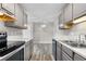Bright kitchen with updated cabinets, stainless steel appliances and white marble countertops at 10211 Ura Ln # 1-202, Thornton, CO 80260